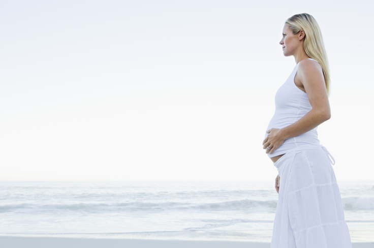 Pregnant woman on a dune